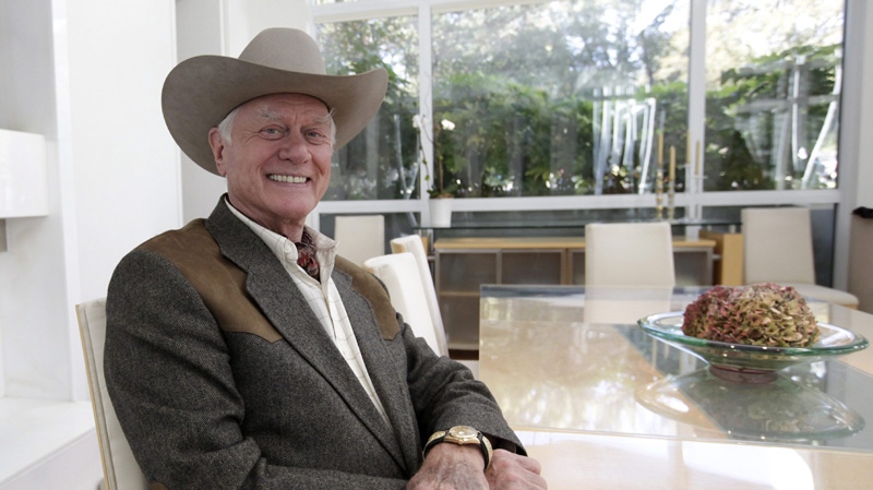 In this Nov. 4, 2011 photo, actor Larry Hagman smiles as he poses for a photo while giving an interview on location during the filming for the upcoming new series "Dallas" in Dallas. 