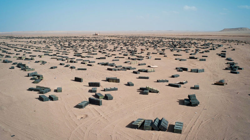 Munition crates are seen at an unguarded storage facility in the desert, around 100 kilometers south of Sirte, Libya on Oct. 26, 2011. (AP / David Sperry)