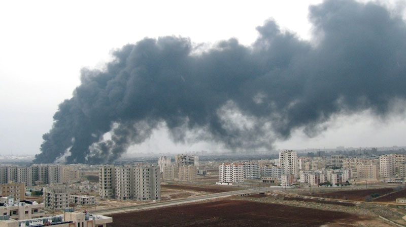 This photo released by the Syrian official news agency SANA made available Friday, Dec. 9, 2011, purports to show smoke enveloping part of the city Homs, Syria, Thursday, Dec. 8, 2011. (AP / SANA)