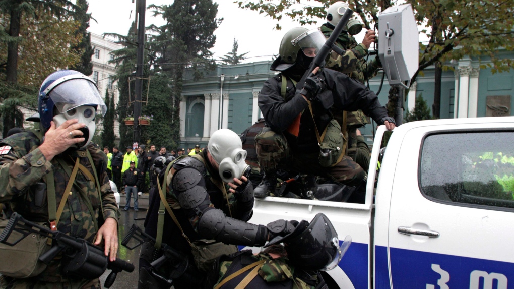 Security forces prepare to confront anti-government protesters with a long-range acoustic device outside the parliament in Tbilisi, Georgia, in this 2007 file photo. (AP Photo/George Abdaladze) 