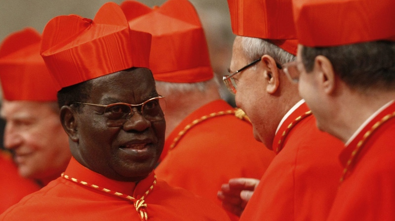 In this Saturday, Nov. 20, 2010 file photo, newly-appointed Cardinal Laurent Monsengwo Pasinya, of the Democratic Republic of Congo, left, is congratulated by other cardinals after being elevated by Pope Benedict XVI during a consistory inside St. Peter's Basilica, at the Vatican. (AP Photo/Pier Paolo Cito)