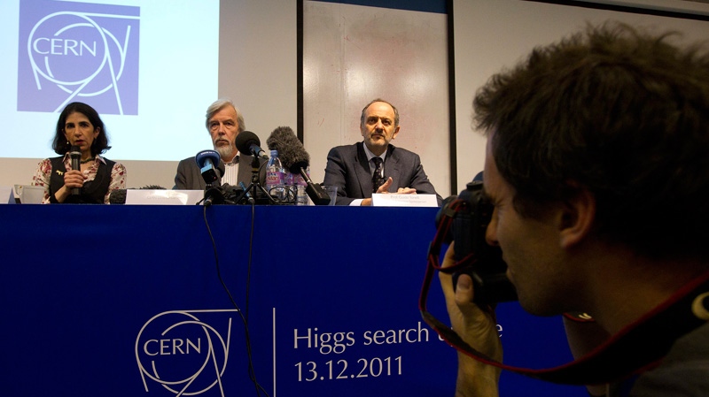 Professor Fabiola Gianotti, left, Atlas Collaboration Spokesperson, German Rolf-Dieter Heuer, centre, Director General of CERN and Professor Guido Tonelli, right, CMS Collaboration Spokesperson, inform the media about the Higgs search, during a press conference at CERN, in Geneva, Switzerland, Tuesday, Dec. 13, 2011. (AP /Keystone/Salvatore Di Nolfi)