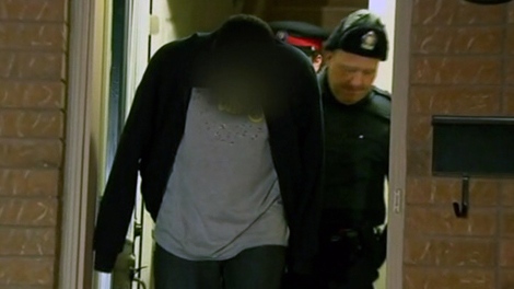 A suspect is arrested by Toronto police during early-morning raids across Toronto and the GTA, Tuesday, Dec. 13, 2011.
