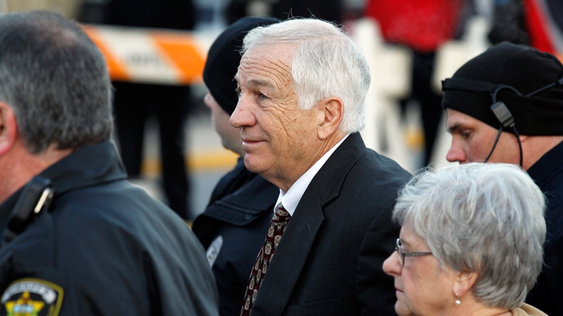 Jerry Sandusky, centre, the former Penn State assistant football coach charged with sexually abusing boys, arrives for a preliminary hearing at the Centre County Courthouse in Bellefonte, Pa., where he will face his accusers Tuesday, Dec. 13, 2011. (AP / Alex Brandon)