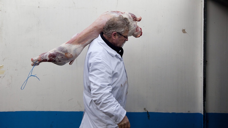 Ritually slaughtered lamb is delivered at a halal butcher shop on the market in The Hague, Netherlands, Tuesday Dec. 13, 2011. (AP Photo/Peter Dejong)