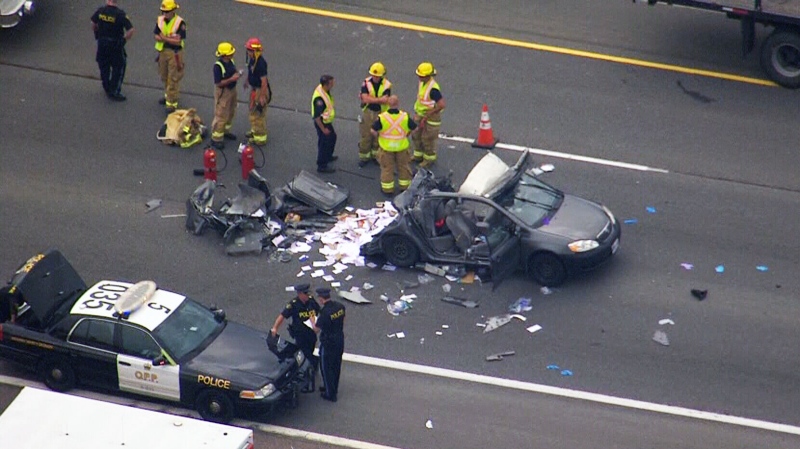 A smashed vehicle is parked on Highway 401 after a serious collision in Whitby, Ont. on Tuesday, June 24, 2014. 
