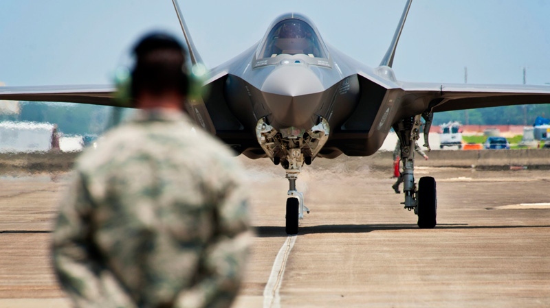 In this photo taken on July 14, 2011 and released by U.S. Air Force, Tech. Sgt. Brian West watches an F-35 Lightning II approach for the first time at Eglin Air Force Base, Fla. Japan's government has selected the Lockheed Martin F-35 stealth fighter to bolster its aging air force and is likely to announce the multibillion-dollar deal by the end of the week, news reports said Tuesday, Dec. 13, 2011. (U.S. Air Force, Samuel King Jr.)
