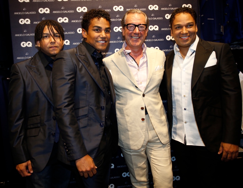 3T pop group members from left, Taj, TJ and Taryll, nephews of late pop star Michael Jackson pose with Italian fashion designer Angelo Galasso, second right, in Milan on June 23, 2014. (AP Photo/Luca Bruno)