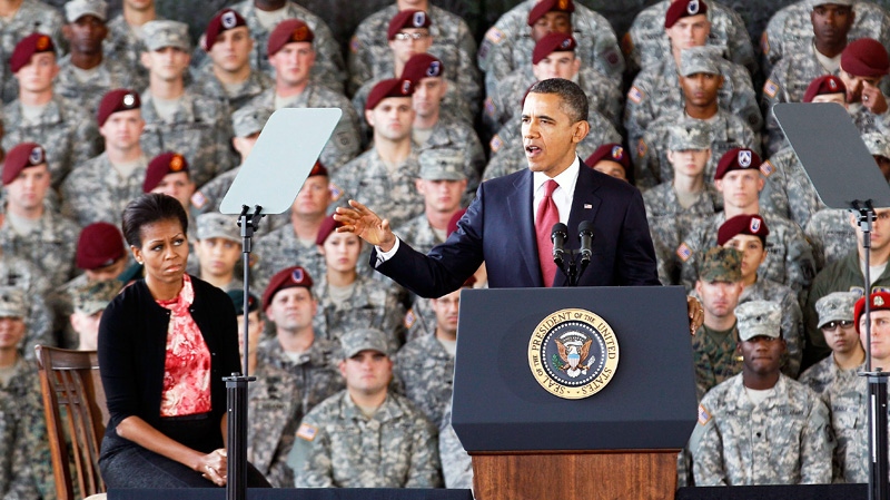 U.S. President Barack Obama, accompanied by first lady Michelle Obama, speaks to troops at Fort Bragg, N.C., Wednesday, Dec. 14, 2011. (AP / Gerry Broome)