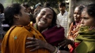 An Indian woman is comforted as she cries after hearing her relative's death from toxic alcohol outside a hospital in Diamond Harbour, near Kolkata, India, Thursday, Dec. 15, 2011.