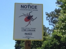 A sign warning parkgoers about the presence of deer ticks in Turkey Point Provincial Park is seen on Friday, June 27, 2014. (Abigail Bimman / CTV Kitchener)