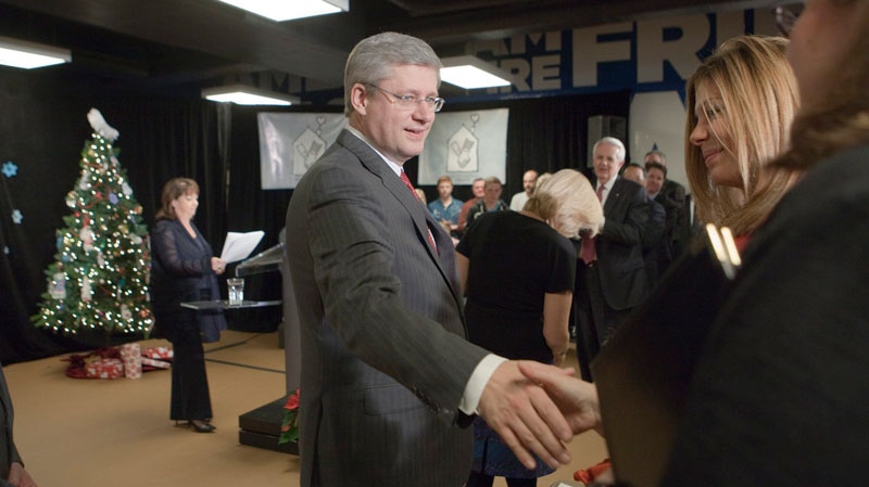 Prime Minister Stephen Harper shakes hands upon his arrival at a press conference at a Ronald McDonald House in Toronto on Friday December 16, 2011. (THE CANADIAN PRESS/Pawel Dwulit)