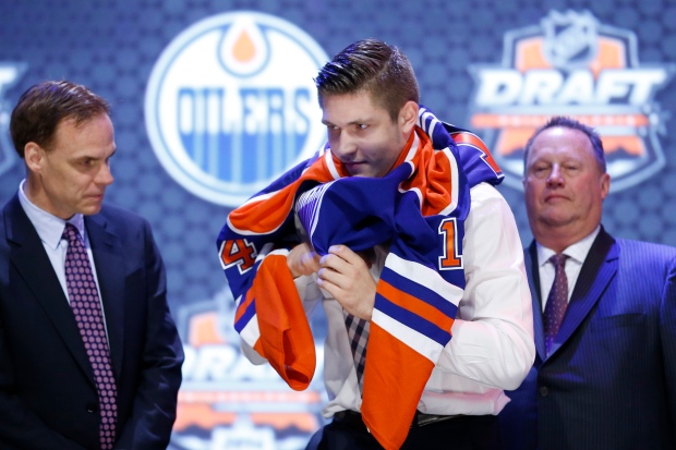 Leon Draisaitl pulls on an Edmonton Oilers sweater