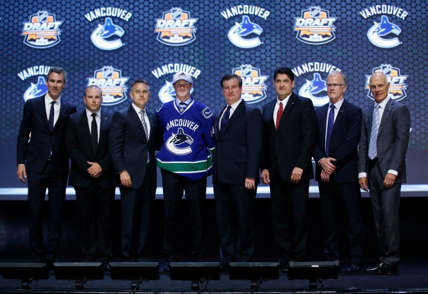 Jared McCann stands with Vancouver Canucks