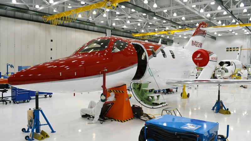 A worker manufactures a HondaJet, light business jet featuring unique engine mount design due to be delivered from 2012, at the Honda Aircraft Co. plant in Greensboro, North Carolina, Wednesday, July 13, 2011. (AP Photo/Kyodo News) 