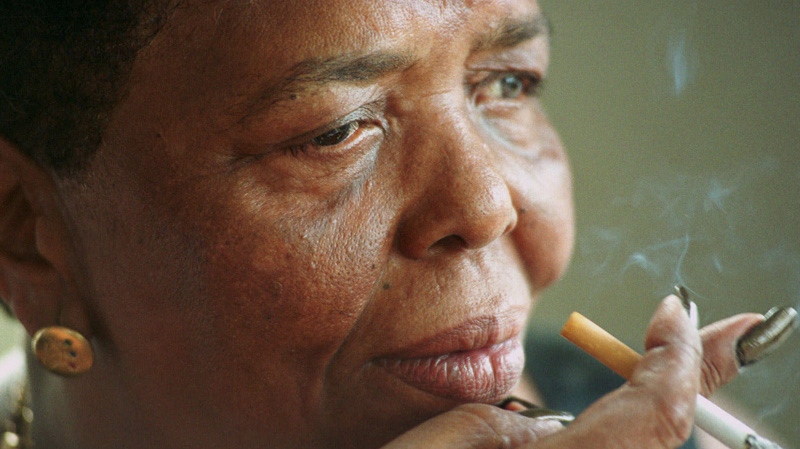 In this Sept. 7, 2000 file photo singer Cesaria Evora known as the "Barefoot Diva," smokes a cigarette during an interview at her home in Mindelo, on the Cape Verde island of Sao Vicente. (AP Photo/Armando Franca, file)