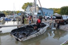 A stolen and burned Elgin OPP police boat is seen being pulled from the water in Port Stanley, Ont. on Wednesday, June 25, 2014. (Katey Berzins/ Facebook)