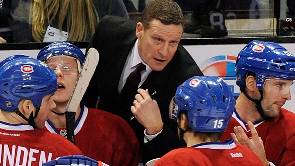 Montreal Canadiens interim head coach Randy Cunneyworth, center, talks with players during the first period of an NHL hockey game against the New Jersey Devils in Montreal, Saturday, Dec. 17, 2011. (AP Photo/The Canadian Press, Graham Hughes)