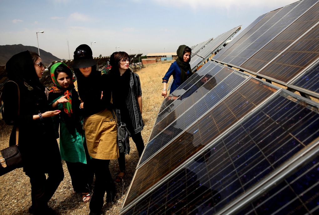 Iranian students tour a solar panel site