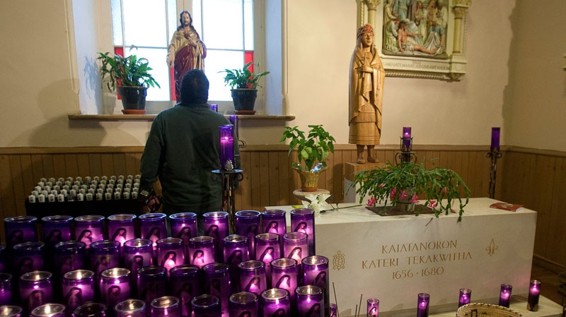 A man looks at the tomb of Kateri Tekakwitha at St. Francis Xavier Church, Monday, December 19, 2011 in Kahnawake, Que, south of Montreal. (Ryan Remiorz / THE CANADIAN PRESS)