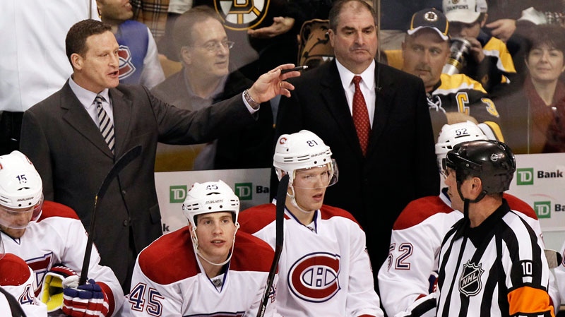 Montreal Canadiens coach Randy Cunneyworth talks to a referee from behind the bench during the second period of an NHL hockey game against the Boston Bruins in Boston