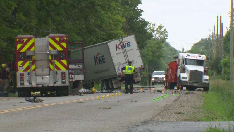 The scene of a fatal crash between a passenger vehicle and a tractor-trailer is seen on Old Beverly Road in North Dumfries, Ont., on Wednesday, July 2, 2014.