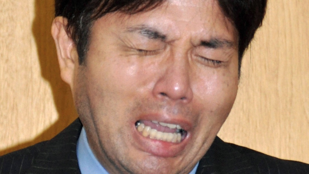 Ryutaro Nonomura cries during a press conference