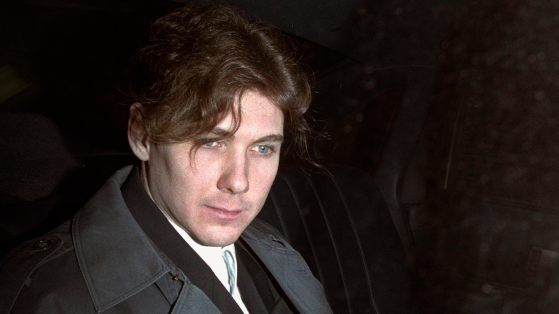 Paul Teale (aka Paul Bernardo) sits in the back of a police cruiser as he leaves a hearing in St. Catharines, Ont., April 5, 1994. (Frank Gunn / THE CANADIAN PRESS)