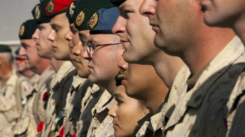 In this November 11, 2011 file photo, Canadian soldiers take part in the last Remembrance Day ceremony at Kandahar Air Field, Afghanistan.  THE CANADIAN PRESS/Ryan Remiorz