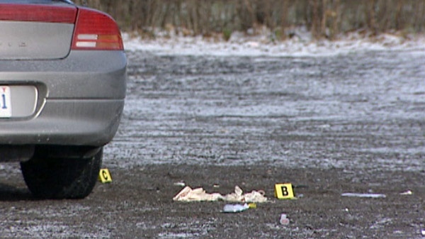 Evidence markers are visible at the scene of a murder outside the Masonic Lodge in Cambridge, Ont. on Saturday, Dec. 17, 2011.