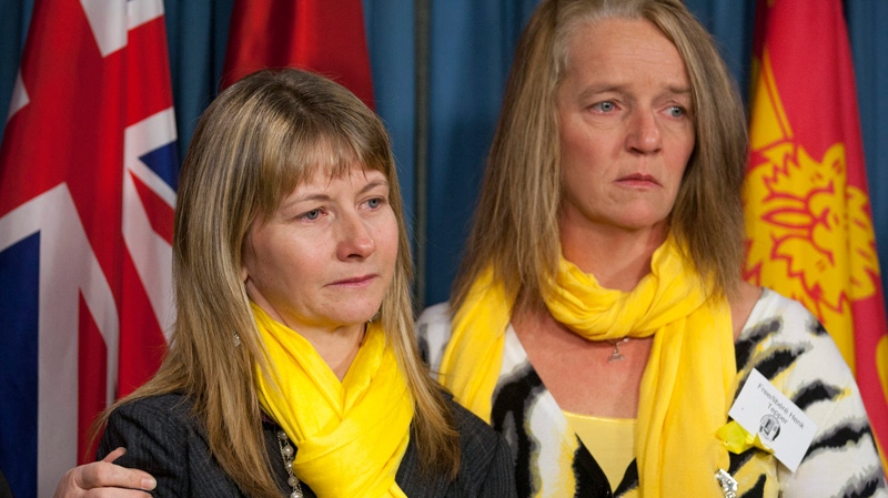 Harmein Dionne, right, New Brunswick potato farmer Henk Tepper's sister, comforts Ella Tepper, left, Henk's wife, during a news conference on Parliament Hill in Ottawa, Tuesday, Dec. 20, 2011. Tepper is currently being detained in prison in Beirut, Lebanon. (Adrian Wyld / THE CANADIAN PRESS)