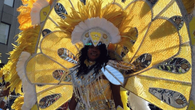 'It only weighs 5 pounds, mainly feathers,' says this bedecked lady at Carifiesta (CTV Montreal / Max Harrold)