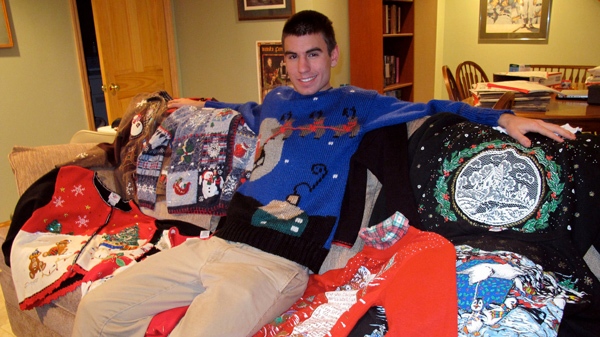 In this picture taken Dec. 21, 2011, Jack McCarthy, 17, poses with some sweaters in Wauwatosa, Wis. McCarthy, 17, launched UltimateUglyChristmas.com with his 22-year-old sister last month, and he expects to clear $5,000 in profit this year. 