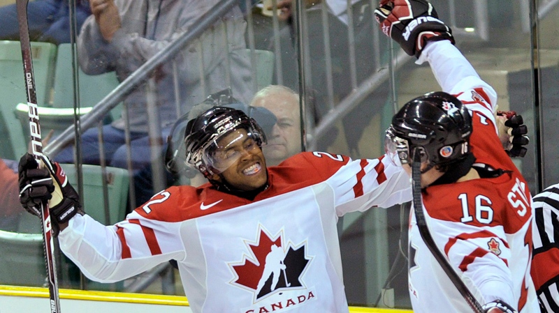 Team Canada forward Devante Smith-Pelly, left, reacts with teammate Mark Stone after scoring against Team Switzerland during third period exhibition hockey action in preparation for the upcoming IIHF World Junior Championships in Red Deer, Alta., on Thursday, Dec. 22, 2011. THE CANADIAN PRESS/Nathan Denette
