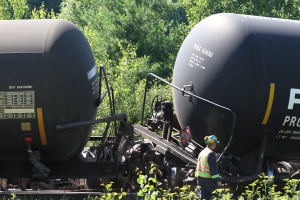A worker looks at the derailed CN train