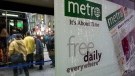 An ad for Metro, a free commuter daily newspaper, is seen on a streetcar shelter in downtown Toronto Tuesday March 13, 2001. (CP PHOTO/Kevin Frayer)