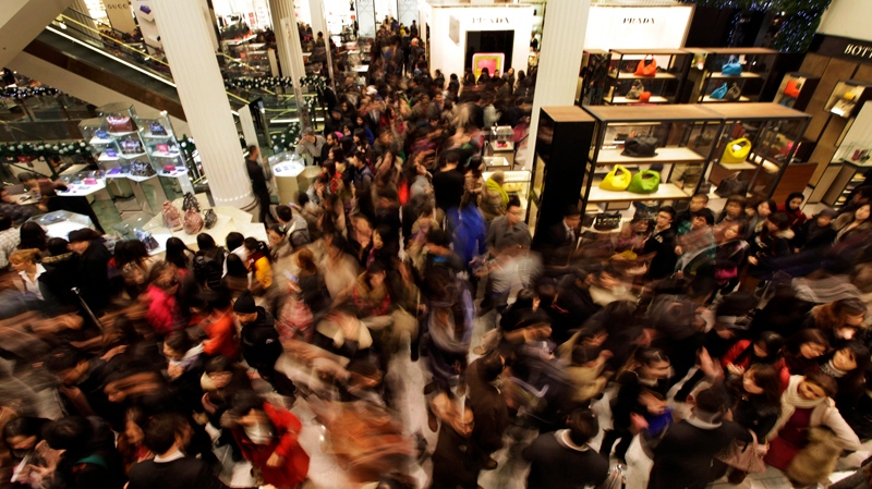 People rush into a department store as it opens for Boxing Day sales in central London, Monday, Dec. 26, 2011.