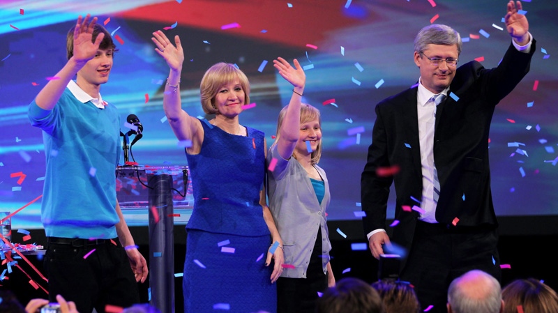 Prime Minister Stephen Harper along with his wife Laureen, daughter Rachel and son Ben wave to the crowd as they arrive on stage following his majority win in Calgary, Alta, Monday, May 2, 2011. 