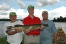 Liberal Leader Stephane Dion (in red) and companions with a tournament-winning northern pike he caught in August 2008.