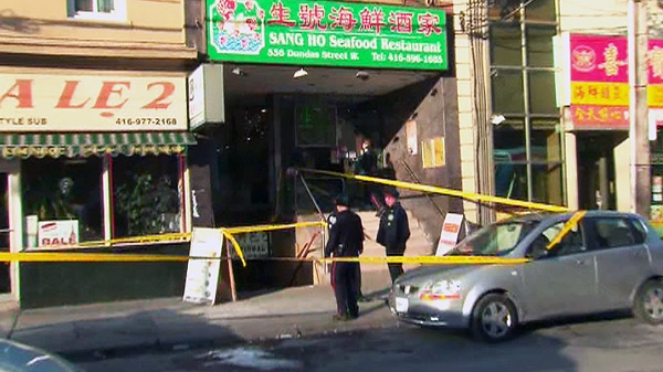 A woman is in hospital and a man in custody following a stabbing in the kitchen of a restaurant on Dundas Street West.