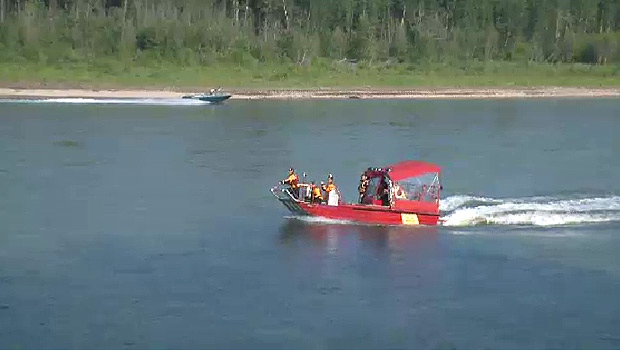 RCMP and emergency crews search the North Saskatchewan River, after a young man was swept away by the current Sunday, July 13.
