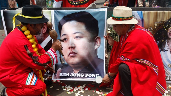 Shamans perform a ritual for good luck in 2012 as they hold up a poster of North Korea's next leader Kim Jong Un in Lima, Peru, Thursday Dec. 29, 2011. (AP / Karel Navarro)