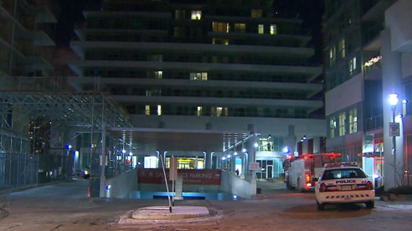 Police are shown at 60 Town Centre Court, where a man tumbled off a balcony late Wednesday, Dec. 29, 2011.