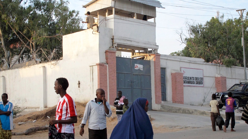 Residents walk outside of the Medecins Sans Frontieres (Doctors without Borders) compound in Mogadishu, Somalia, Thursday, Dec. 29, 2011. (AP / Mohamed Sheikh Nor)