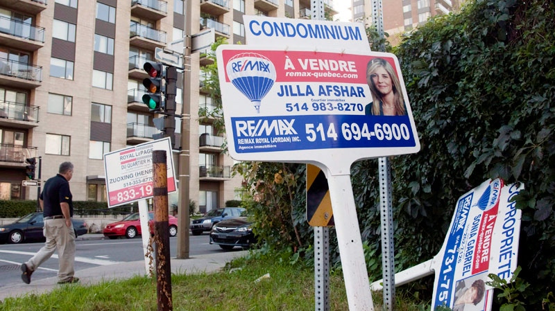 For sale signs stand in front of a condominium in Montreal on Sept. 27, 2011. (Ryan Remiorz / THE CANADIAN PRESS)