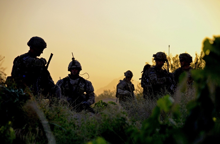 Canadian and U.S. soldiers work their way through a field at sunrise in Zangabad, Afghanistan, on Thursday June 2, 2011. (Murray Brewster / THE CANADIAN PRESS)  