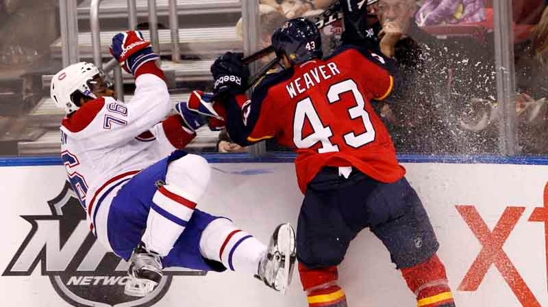 Florida Panthers defenseman Mike Weaver (43) checks Montreal Canadiens defenseman P.K. Subban (76) into the boards during the third period of an NHL hockey game, Saturday, Dec. 31, 2011, in Sunrise, Fla. The Panthers defeated the Canadiens 3-2. (AP Photo/Wilfredo Lee)