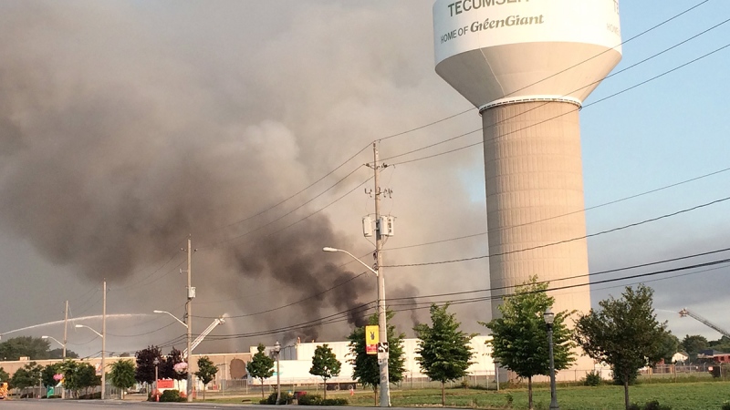Firefighters try to put out a fire at the Bonduelle food-processing plant in Tecumseh, Ont., on Friday, July 18, 2014. (AP / Detroit Free Press, Robert Allen)