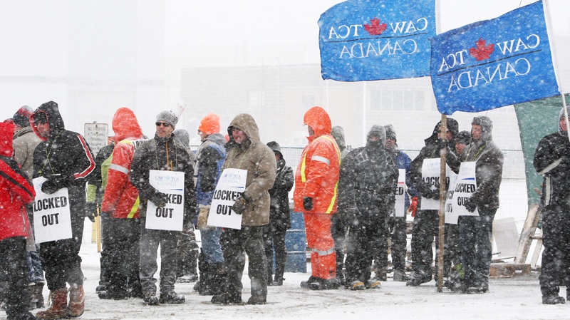 Locked-out workers and supporters picket at the locomotive-maker Electro-Motive facility in London, Ont., Monday, Jan. 2, 2012. (Dave Chidley / THE CANADIAN PRESS)