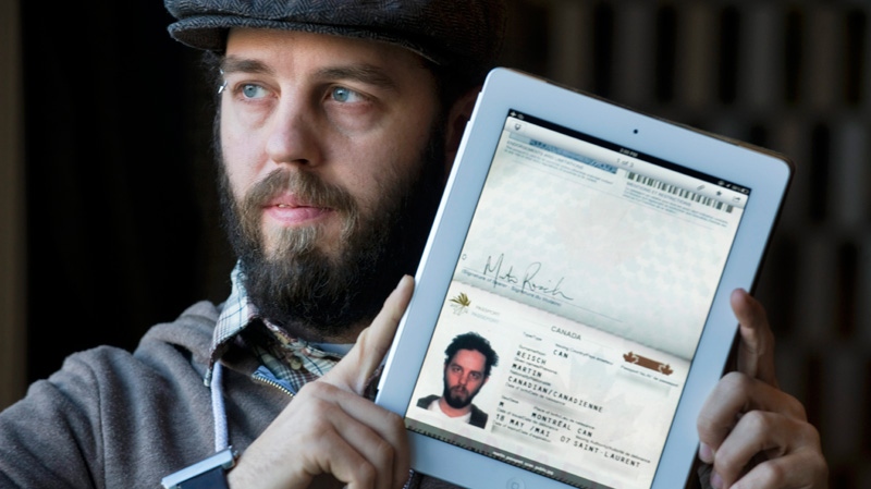 Martin Reisch holds up his iPad displaying his passport in Montreal, Tuesday, Jan. 3, 2012. (Graham Hughes / THE CANADIAN PRESS)